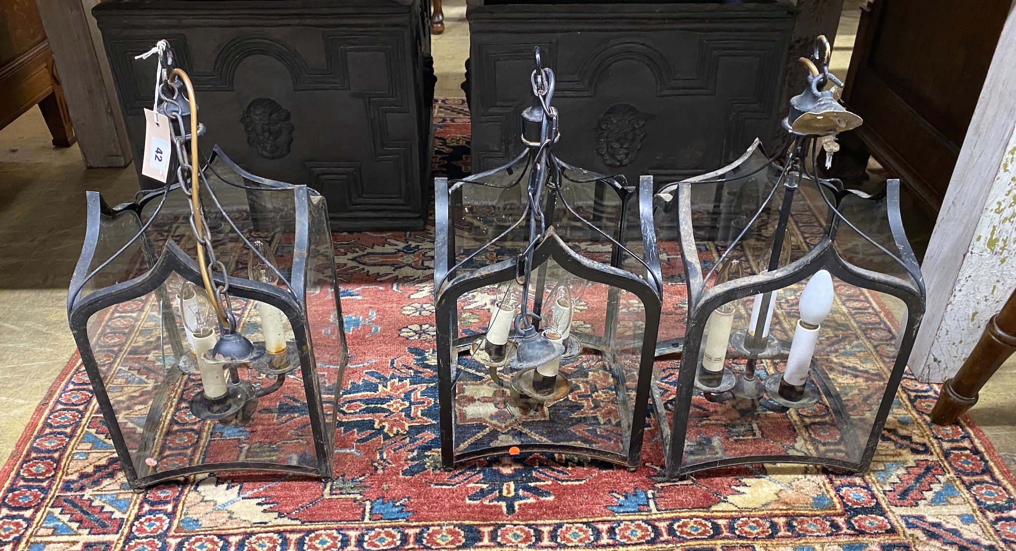 A set of three square glazed metal hall lanterns, height 50cm